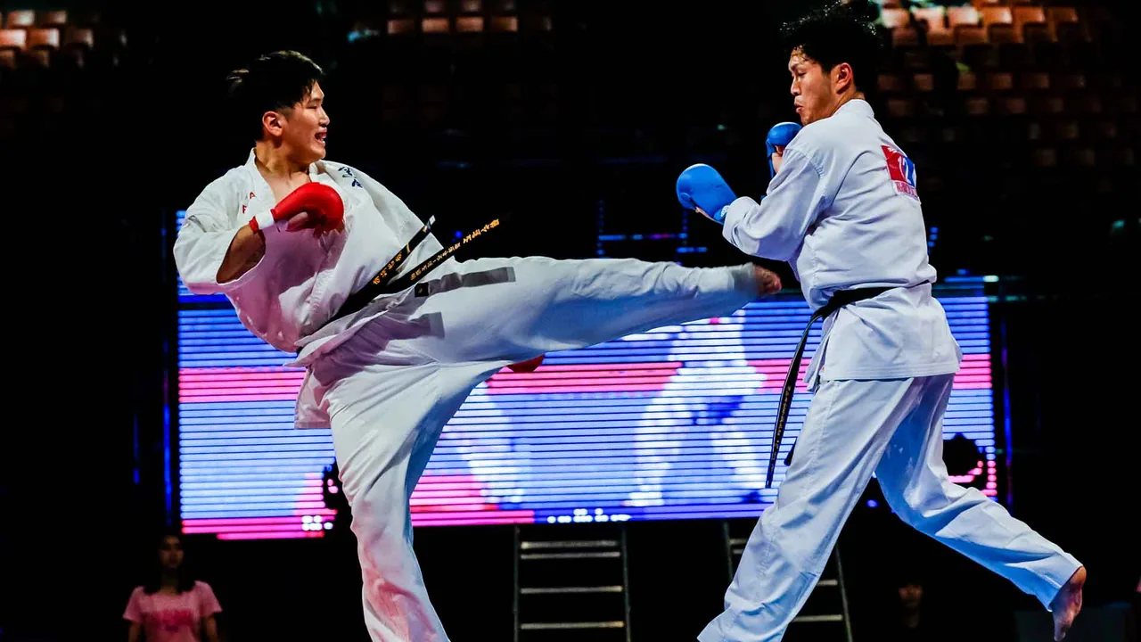 A karate athlete throws a high kick toward an opponent during the 2019 national tournament.